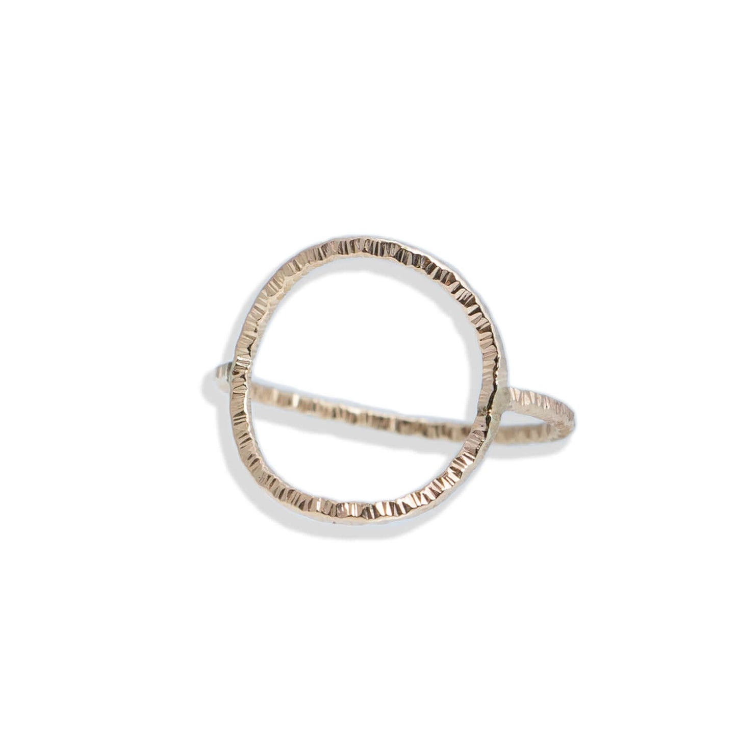 Gold ring with a unique design on a white background
