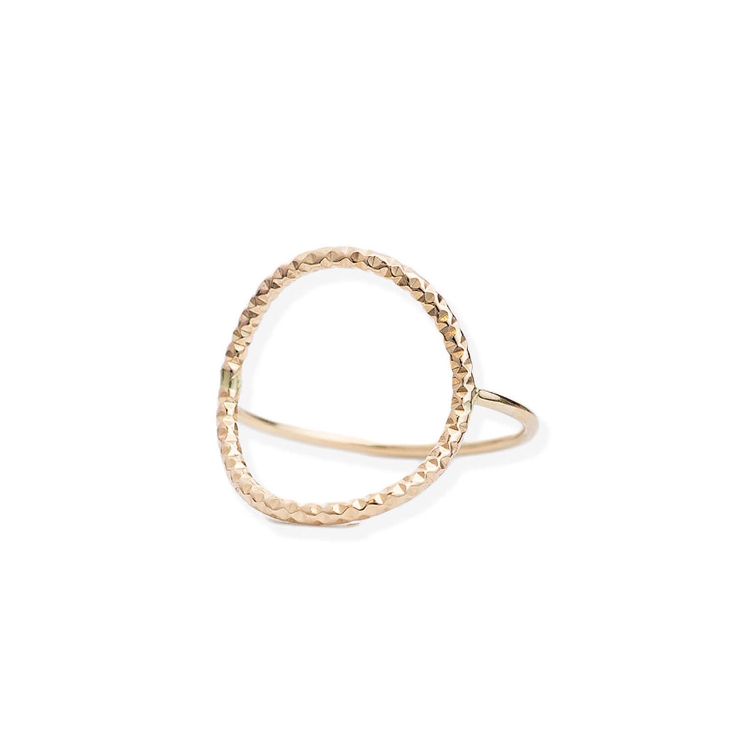 Gold ring with a textured design on a white background