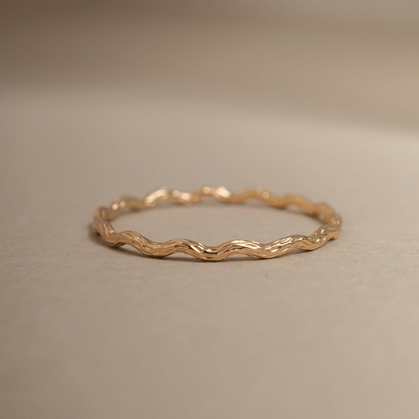 Gold ring on a beige background
