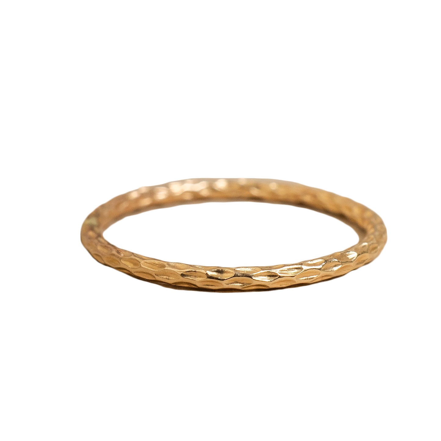 Gold ring with textured design on a white background