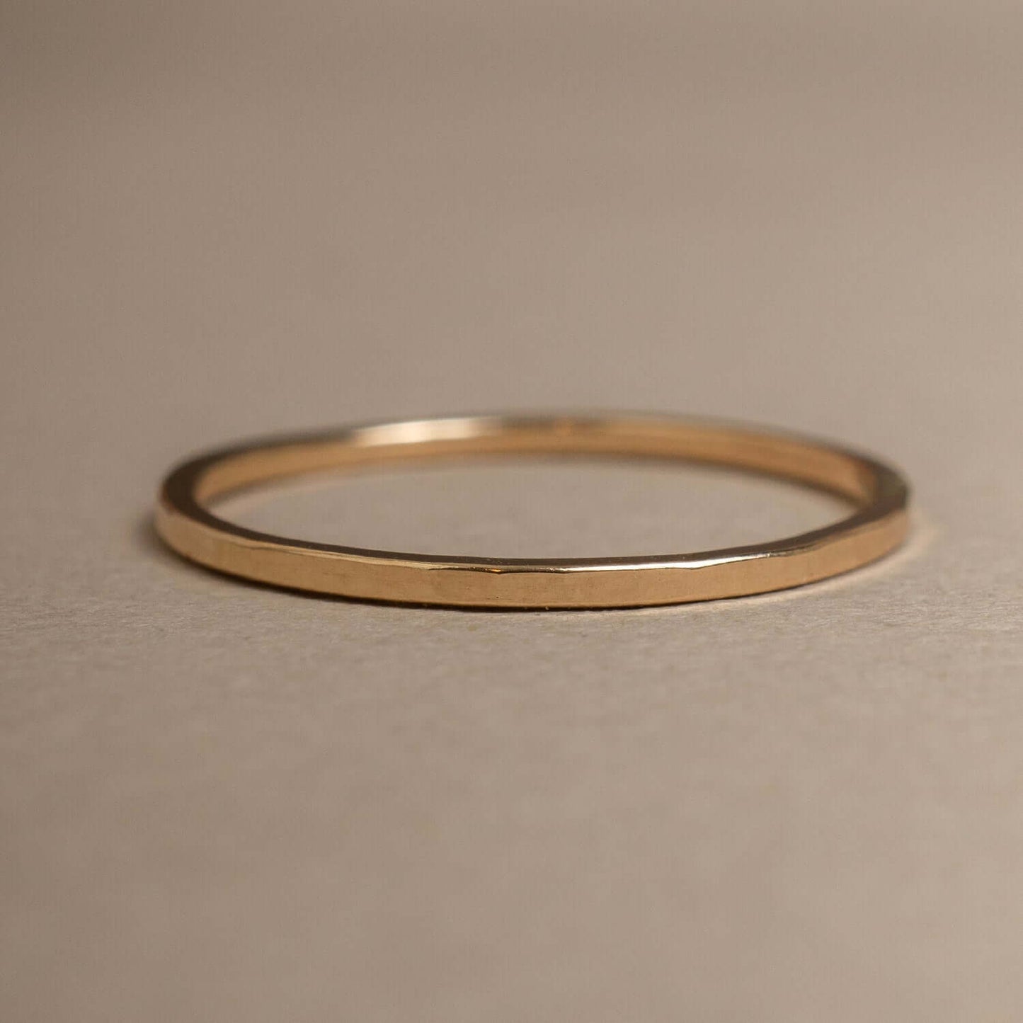 Gold ring on a beige background