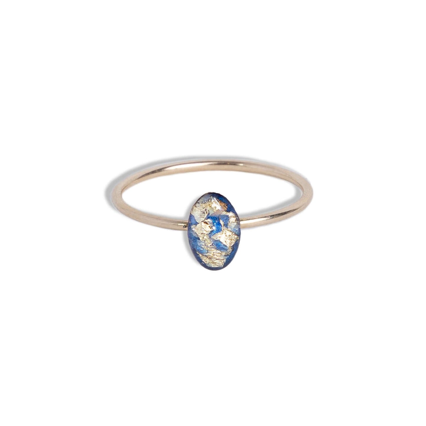 Tiny Blue and Gold Oval Ring with gold leaf on a bright blue background sealed in a glass-like resin crystal.