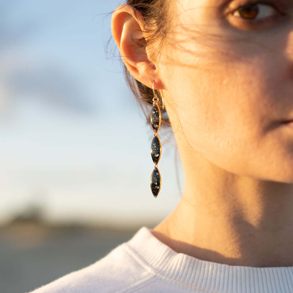 Look of our oval galaxy dangling earrings on a model.