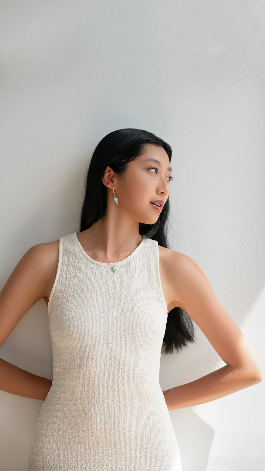 Ocean Blue earring and a necklace set on a model wearing white dress