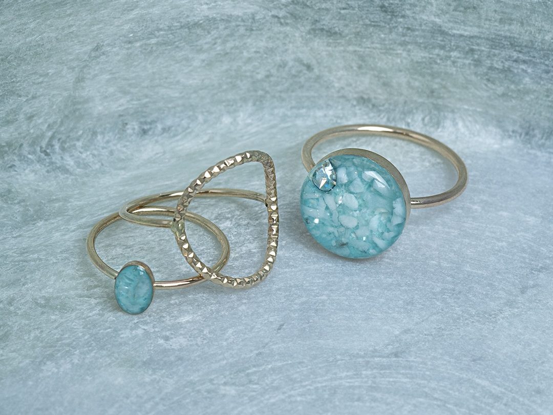 Statement Round Gemstone Ring in Blue Turquoise beside a tiny oval turquoise blue ring and a textured open band, all in gold
