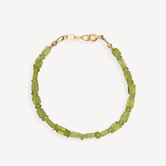 A beaded bracelet made of faceted olive green beads with a gold-tone clasp, shown on a light gray background.