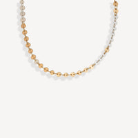 Gold beaded necklace on a white background