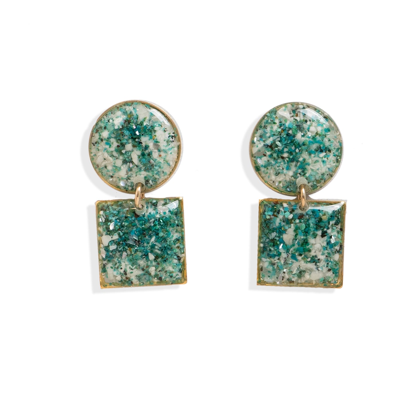 Pair of earrings with green and gold square and round stones on a white background