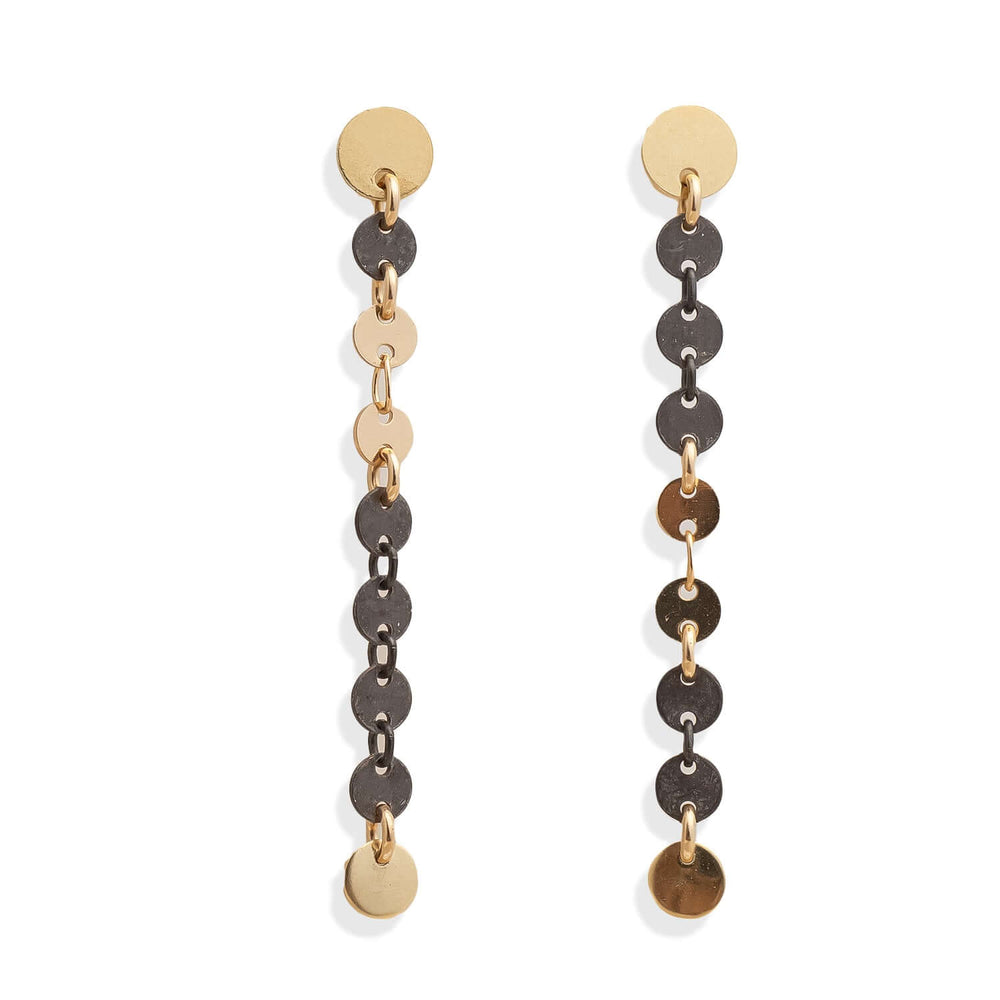 Pair of long, dangling earrings with gold and silver disc and chain designs on a white background.