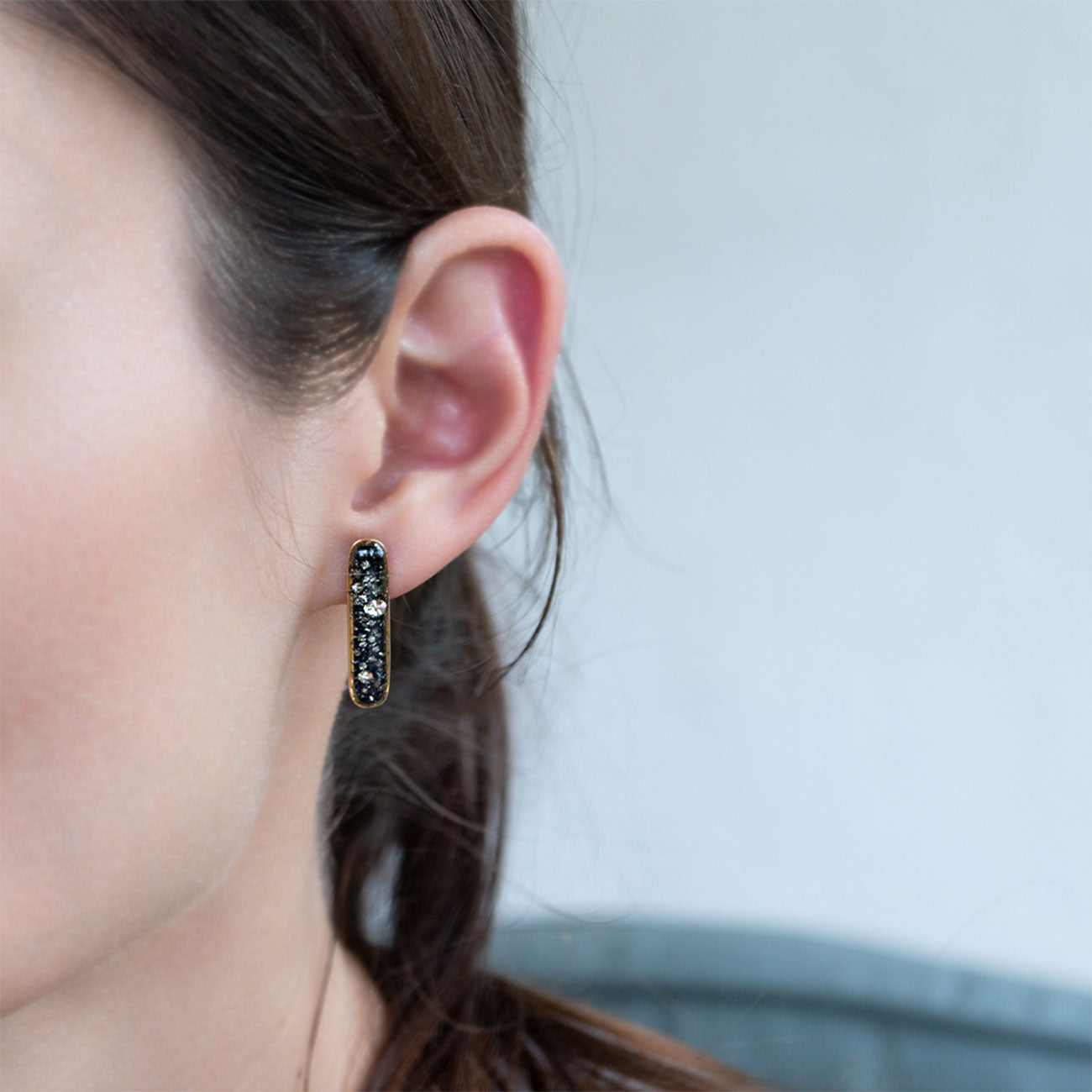 
                  
                    Long Bar Galaxy Earrings with crushed stones are inspired by the pure and authentic energy of the universe.
                  
                