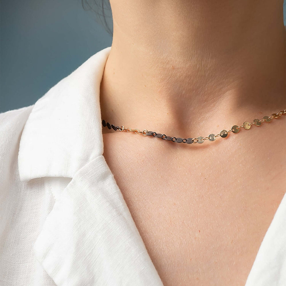 
                      
                        Necklace on a person wearing a white shirt against a neutral background
                      
                    