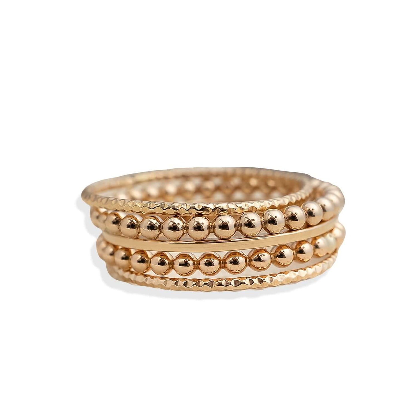 Three gold beaded rings stacked on a white background