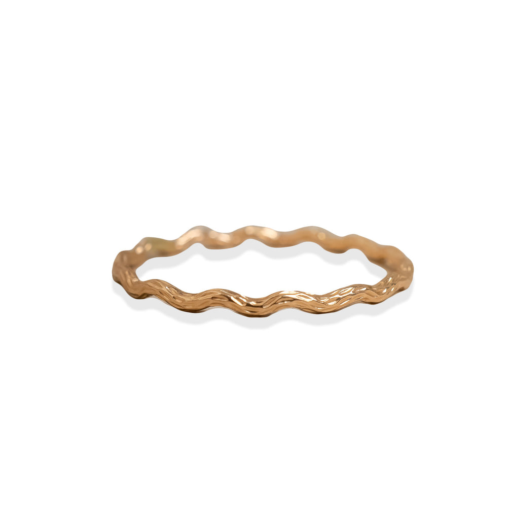 
                      
                        Gold ring with wavy design on a white background
                      
                    