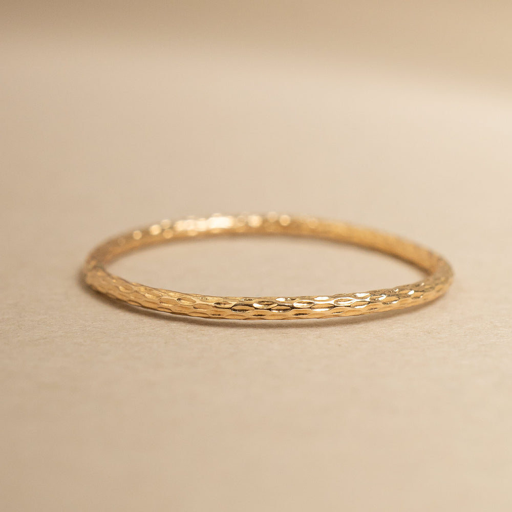 
                      
                        Gold ring on a beige background
                      
                    