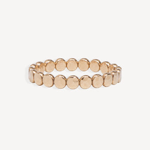 A gold beaded textured dot ring, shown against a plain off-white background.