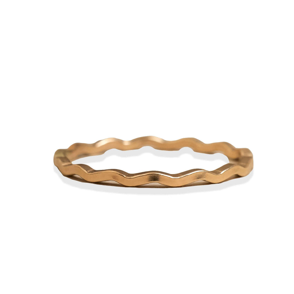 Gold ring with a wavy design on a white background