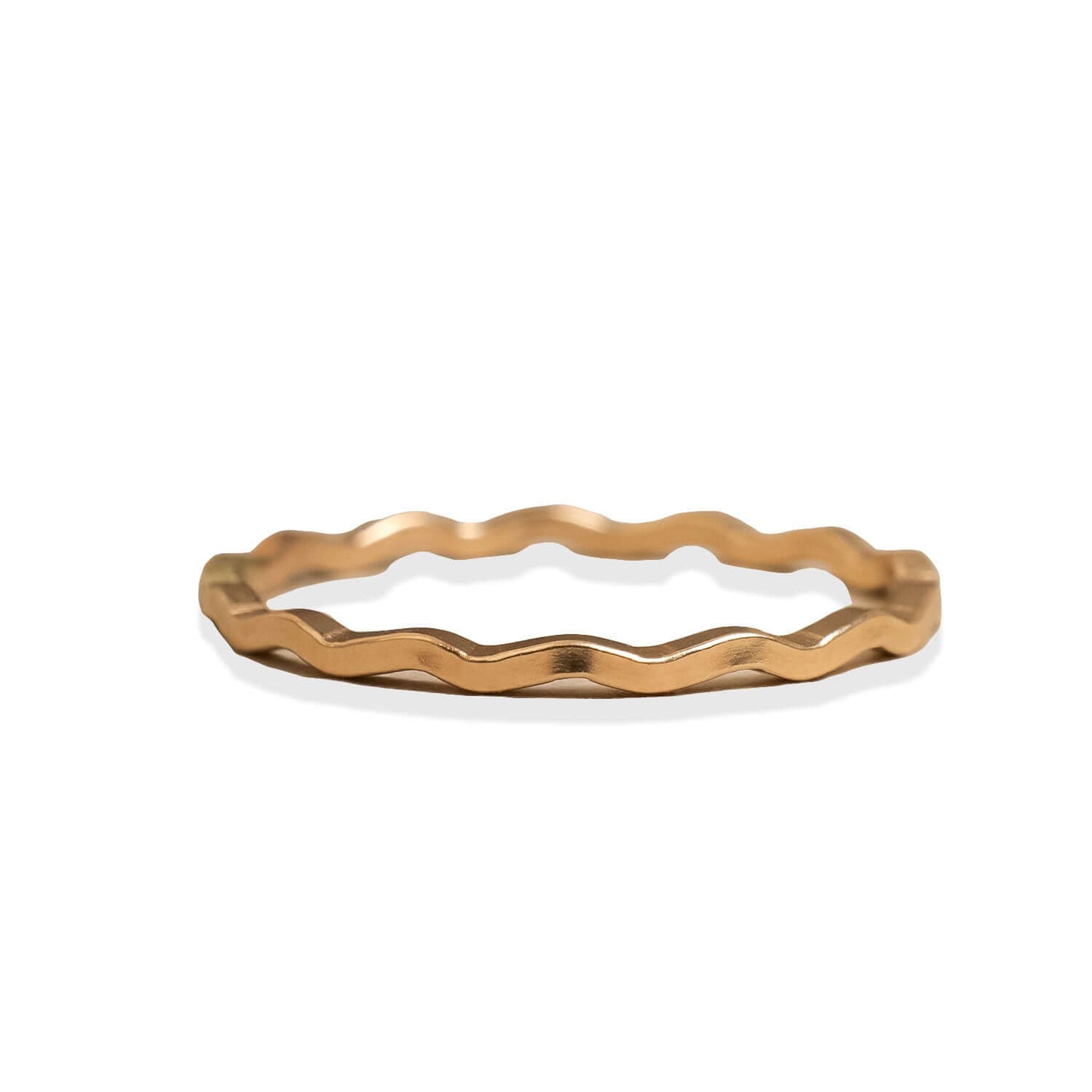 Gold ring with a wavy design on a white background