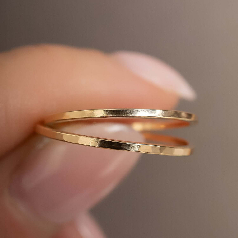 
                      
                        Gold ring on a finger against a neutral background
                      
                    