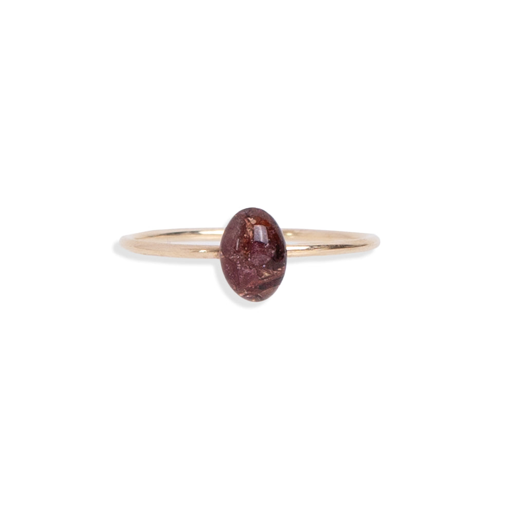 
                  
                    Tiny Oval Garnet ring featuring a shimmering gold-filled band that gracefully wraps around your finger with a deep-red natural crushed Garnet stones encased in a glass-like resin.
                  
                