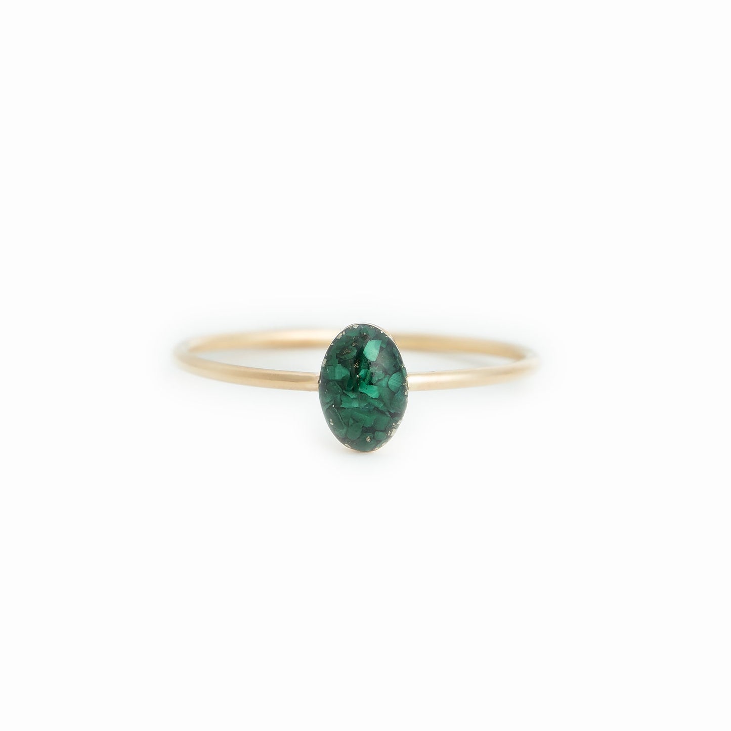 
                  
                    Tiny Delicate green oval ring with tiny Malachite stone pieces captured in glass like resin in three crystal sizes. 
                  
                