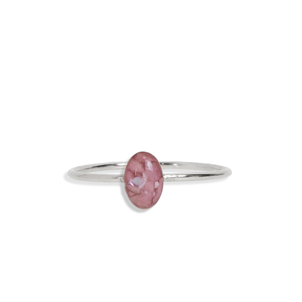 
                  
                    Delicate oval Rhodonite ring with tiny Rhodonite stone pieces captured in glass like resin in three crystal sizes.
                  
                