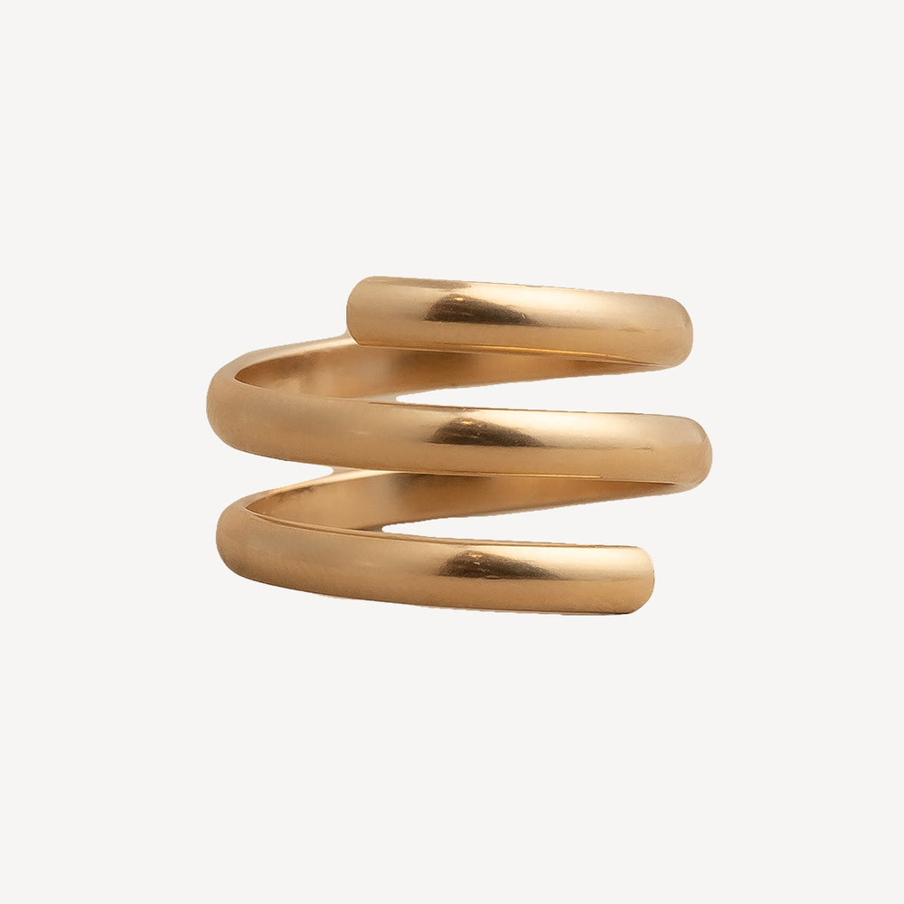 Gold spiral ring on a white background