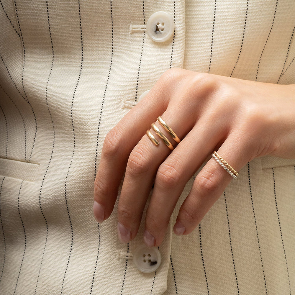 Gold spiral ring on a white background