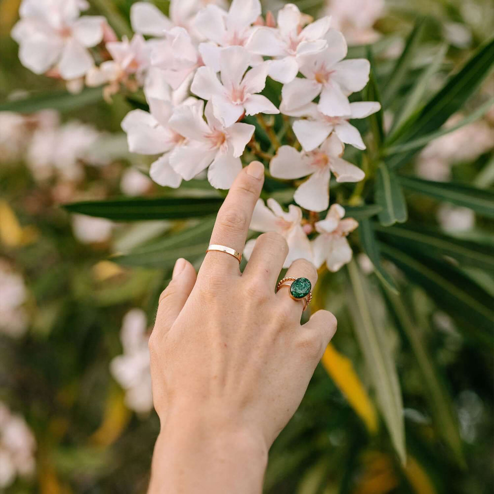 Gold ring with a textured surface on a white background