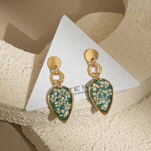 Handcrafted dangling flower earrings with delicate petal details in gold-filled metal by Kate Koel