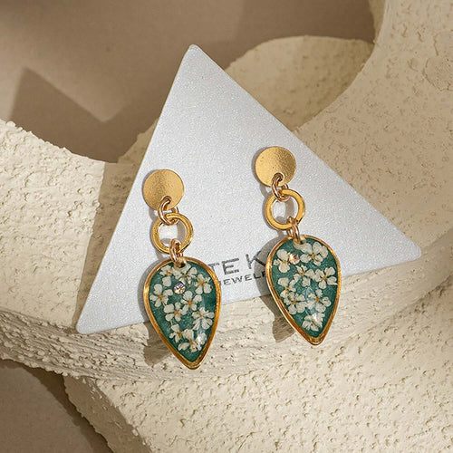 Handcrafted dangling flower earrings with delicate petal details in gold-filled metal by Kate Koel