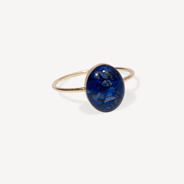 Silver earring with a blue gemstone on a white background
