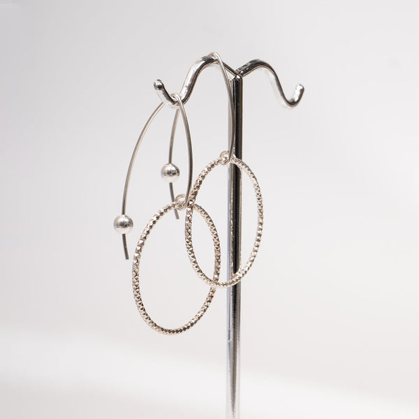 Handcrafted gold-filled disco hoop dangle earrings with textured reflective surface by Kate Koel