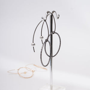 Handcrafted gold-filled disco hoop dangle earrings with textured reflective surface by Kate Koel