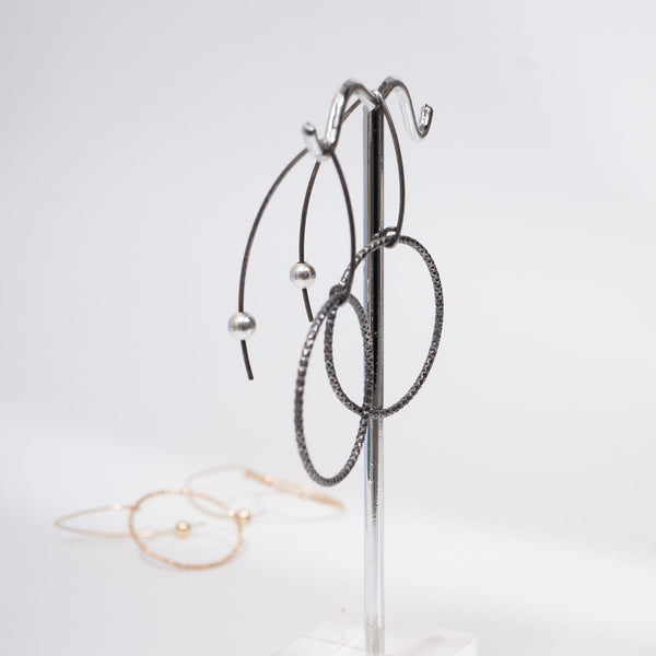 Handcrafted gold-filled disco hoop dangle earrings with textured reflective surface by Kate Koel
