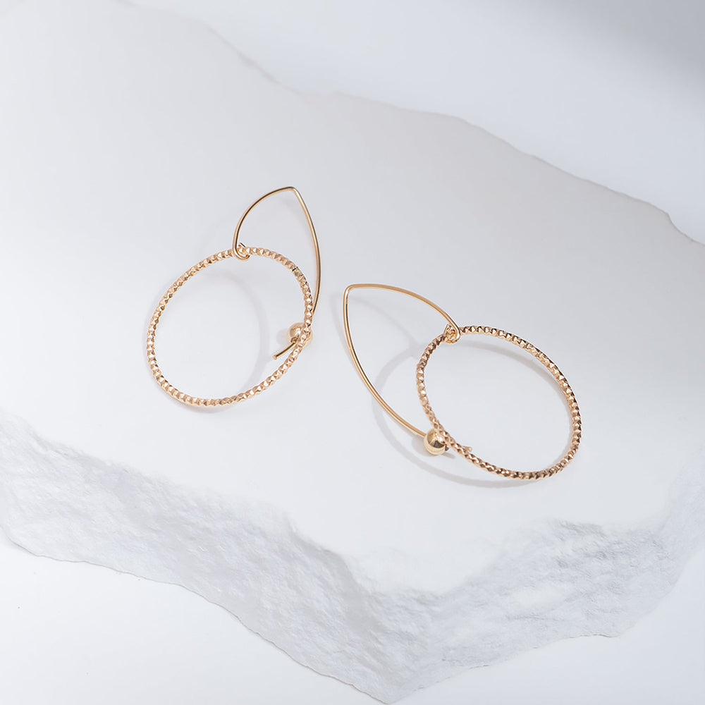 Handcrafted gold-filled disco hoop dangle earrings with textured reflective surface by Kate Koel