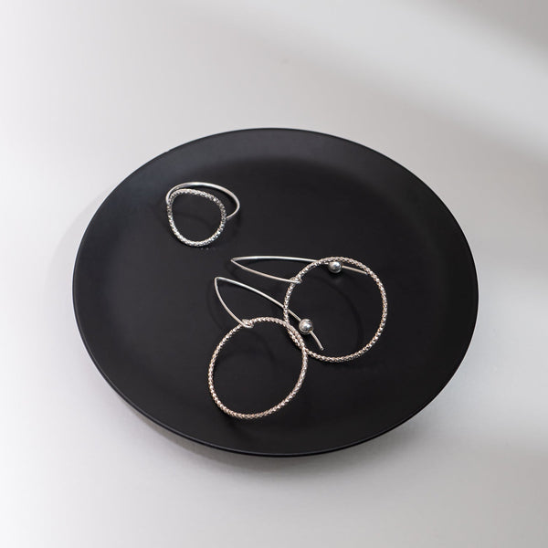 Handcrafted gold-filled disco hoop dangle earrings with textured reflective surface by Kate Koel