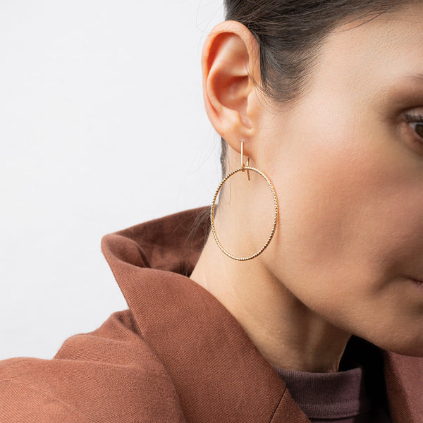 Handcrafted 45mm textured gold-filled disco statement hoop earrings with light-catching sparkle by Kate Koel