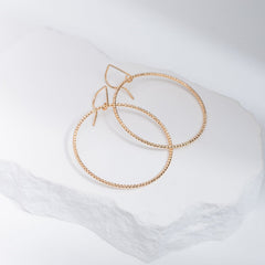 Handcrafted 45mm textured gold-filled disco statement hoop earrings with light-catching sparkle by Kate Koel