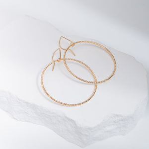 Handcrafted 45mm textured gold-filled disco statement hoop earrings with light-catching sparkle by Kate Koel
