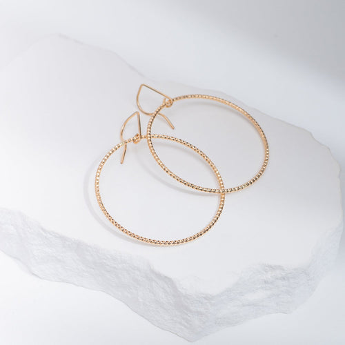 Handcrafted 45mm textured gold-filled disco statement hoop earrings with light-catching sparkle by Kate Koel