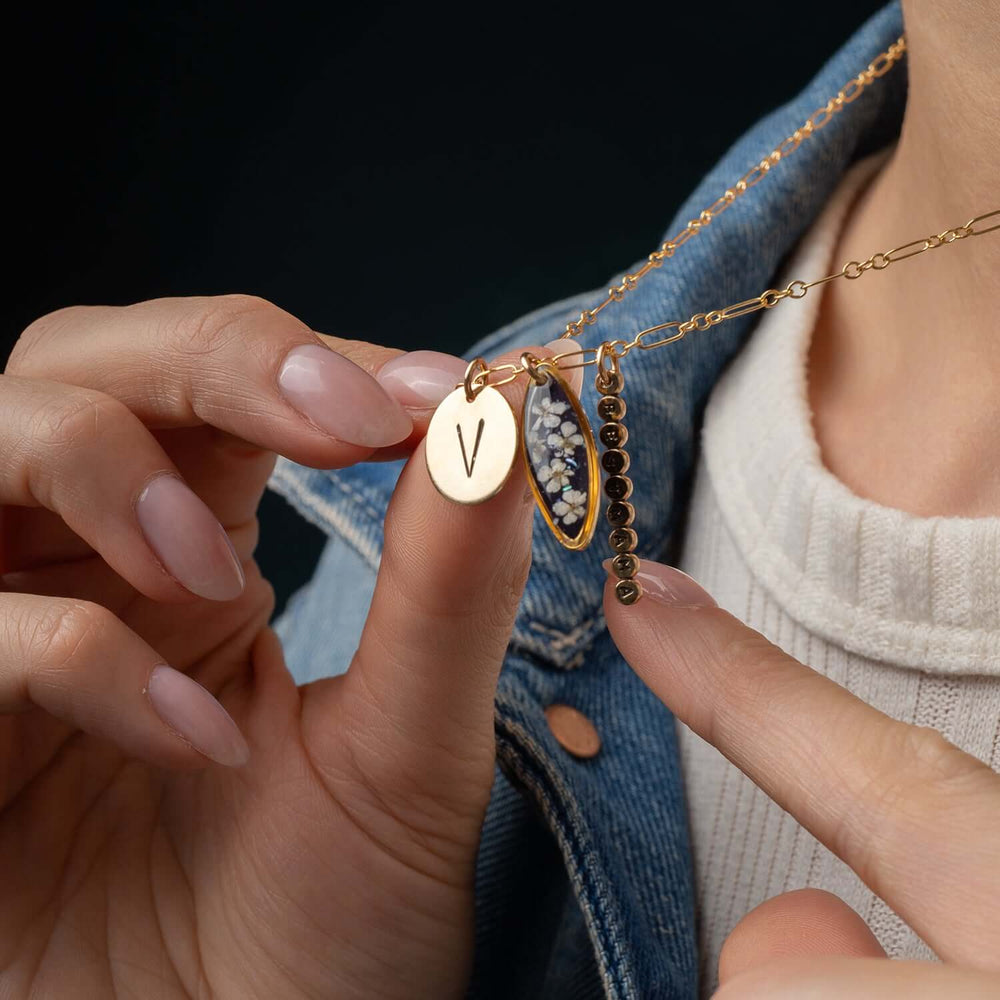 Customizable 14k gold filled floral charm necklace
with pressed flower pendant and hand-stamped initial
charm