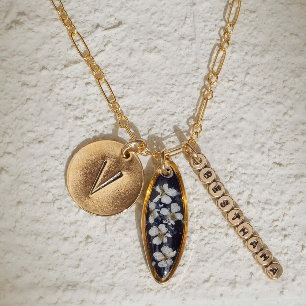 Customizable 14k gold filled floral charm necklace
with pressed flower pendant and hand-stamped initial
charm