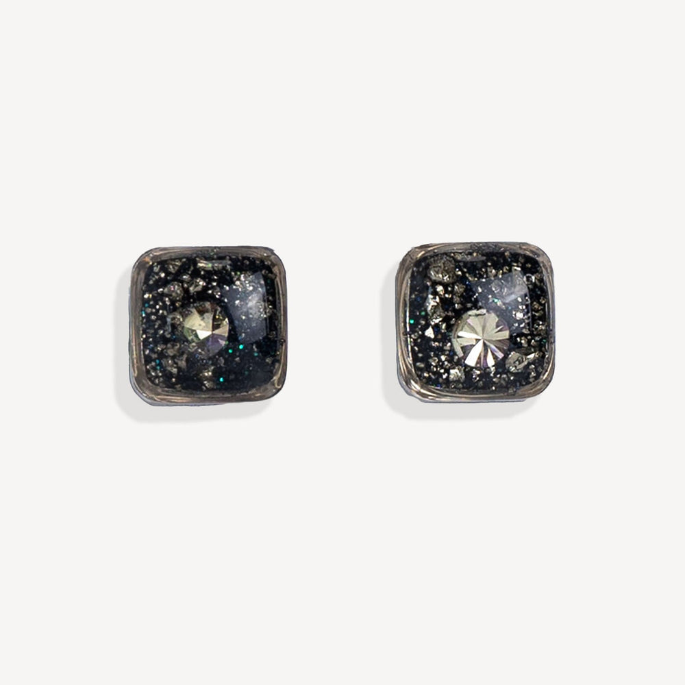 Square-shaped earrings with black and gold design on a white background