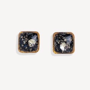 Square-shaped earrings with black and gold design on a white background