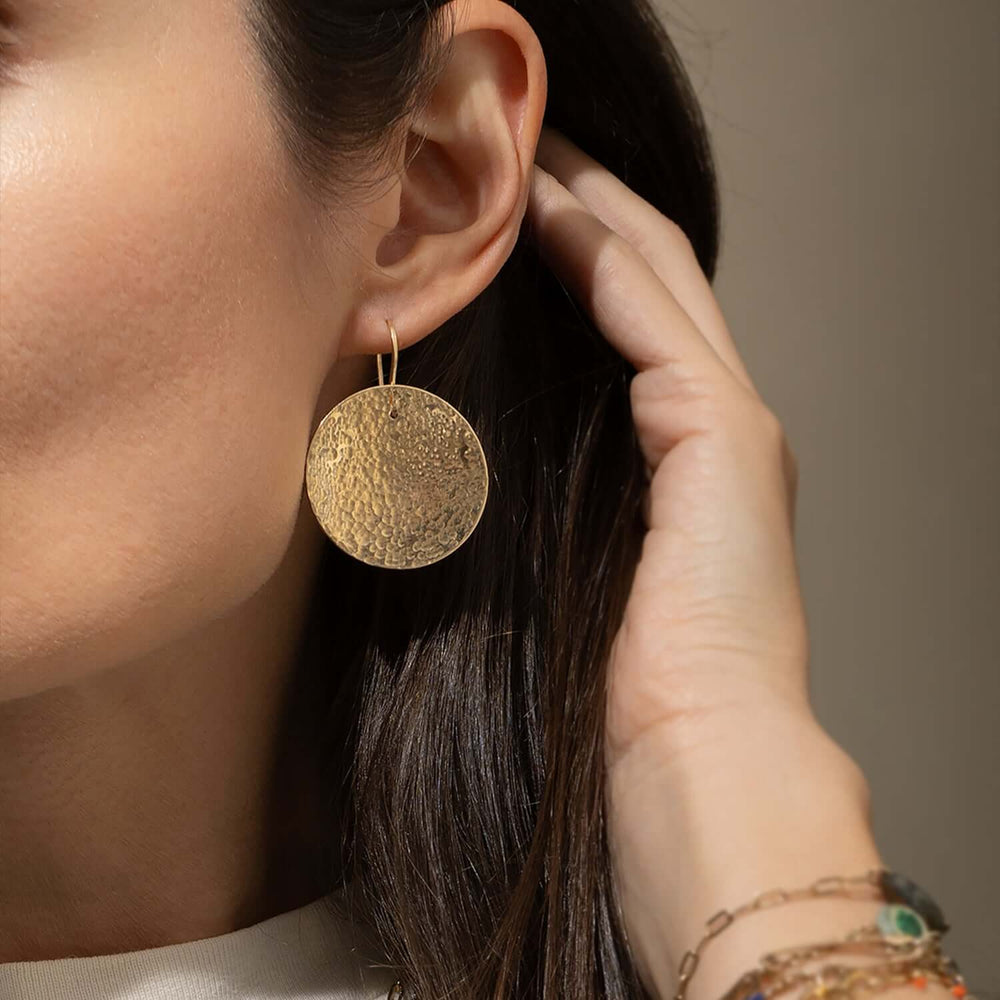 Pair of gold earrings on a white background
