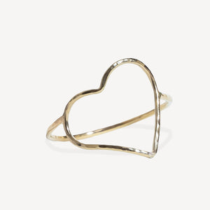 Gold heart-shaped ring on a white background