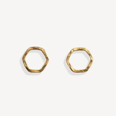 Pair of gold hexagonal earrings on a white background