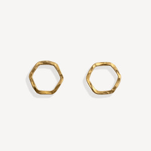 Pair of gold hexagonal earrings on a white background