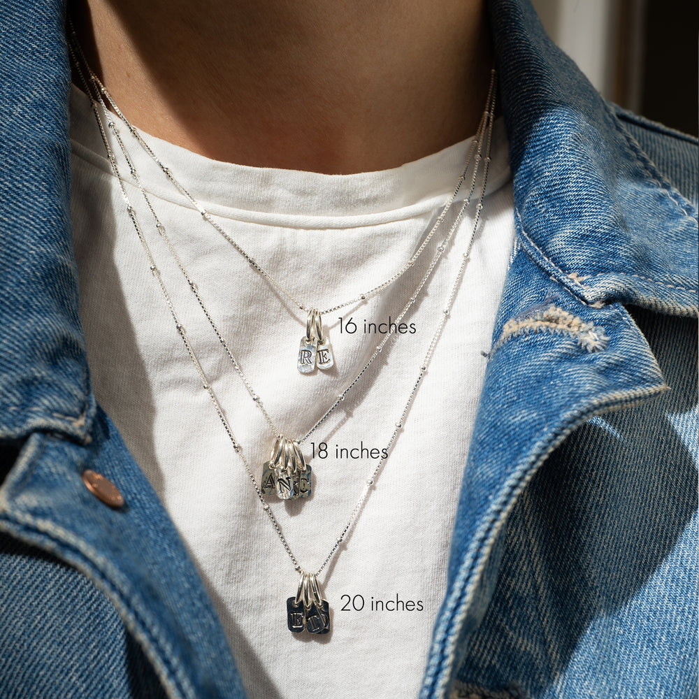 
                      
                        Initial Tag Pendant in Silver
                      
                    