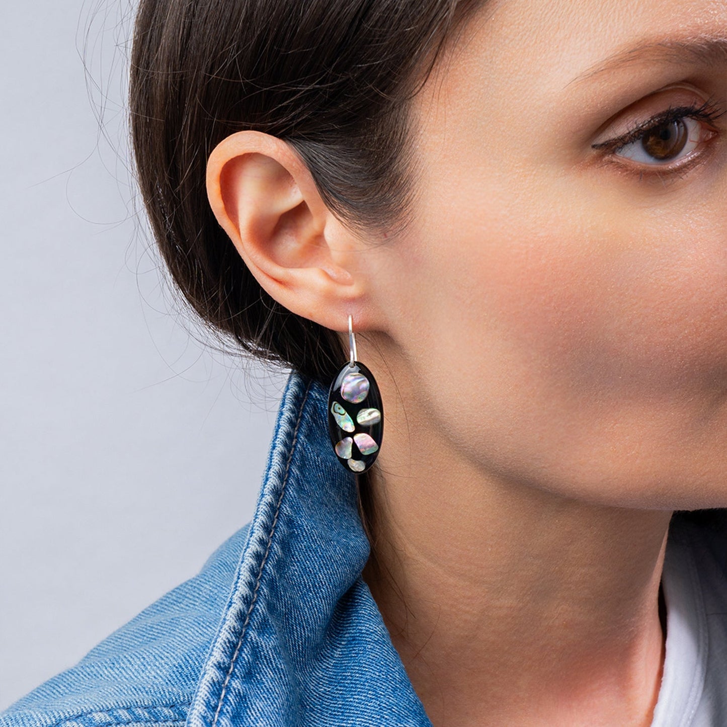 Midnight abalone shell oval drop earrings with genuine iridescent shell on dark background by Kate Koel